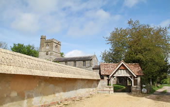 Enford House cottage is next to Enford Church which is and 18th century church with a litchgate entrance 