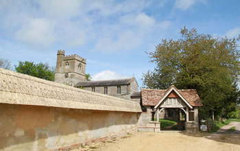 Enford House cottage is next to Enford Church which is and 18th century church with a   litchgate entrance 